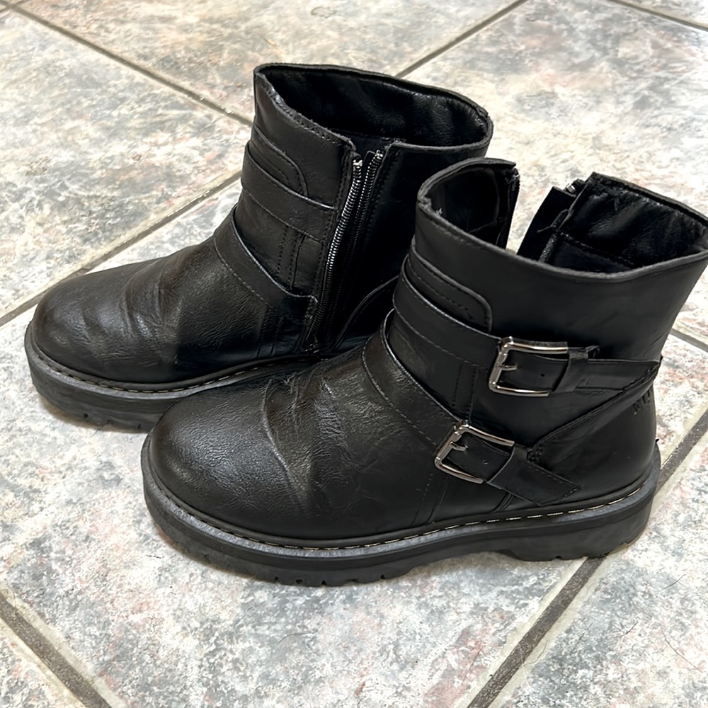 Combat boots with buckles and side zipper.